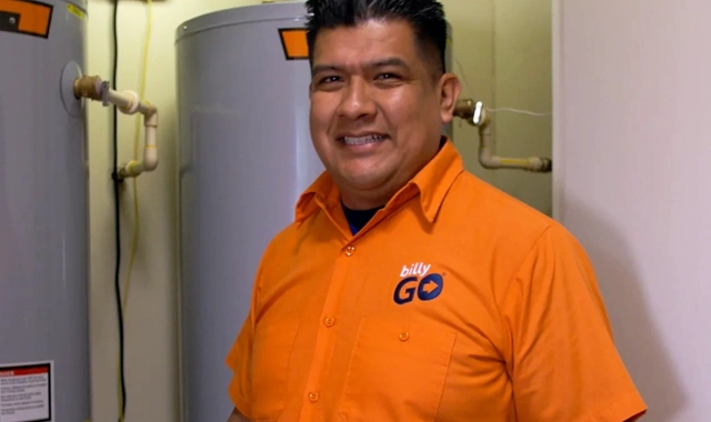 billyGO licensed plumber repairing a water heater in Dallas, TX